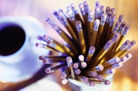 The Adobe Image Library ©1998 Adobe Systems Incorporated Coffee cup and bundle of pencils on table-top
